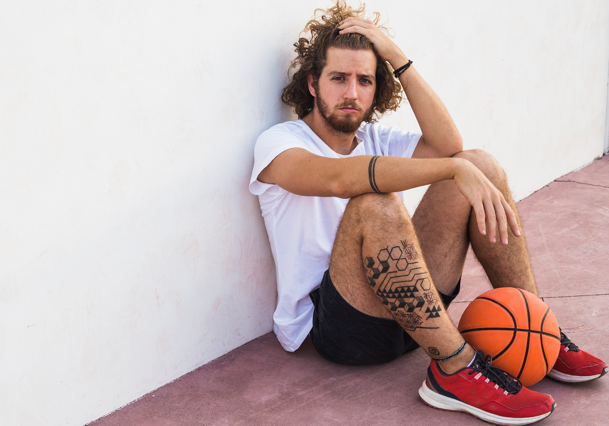 slider_0002_relaxed-basketball-player-sitting-with-ball_5a775f73-c55e-4017-a31f-c083a3ee181f
